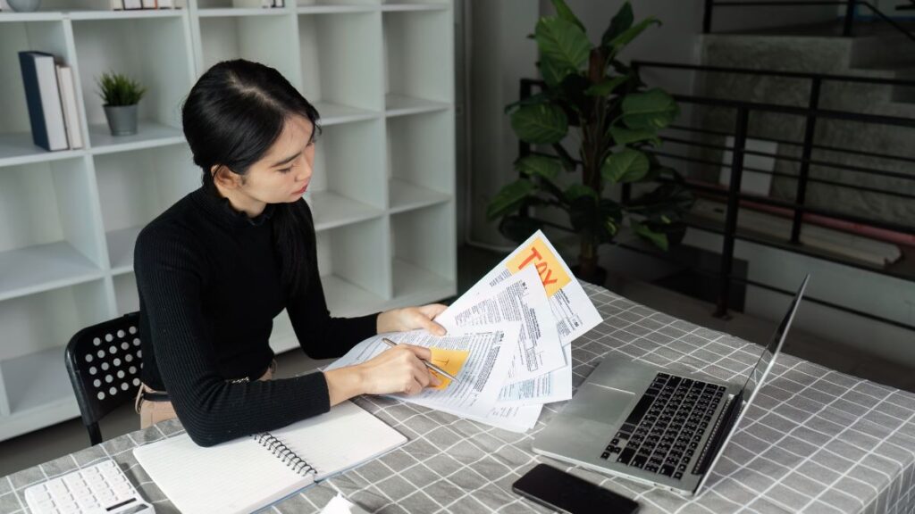 Small business owner reviewing financial documents after filing taxes