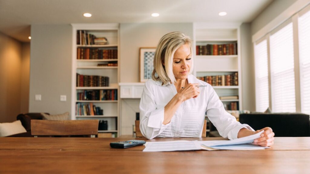 Small business owner reviewing financial documents after filing taxes