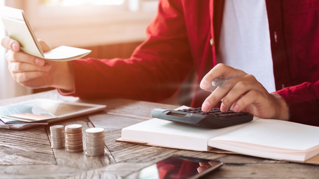 Small business owner reviewing mid-year financials and creating a business budget