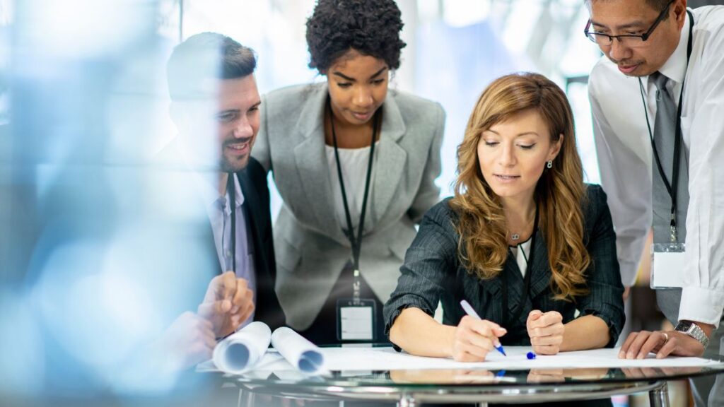Small business owner working with a team preparing finances for the fall season