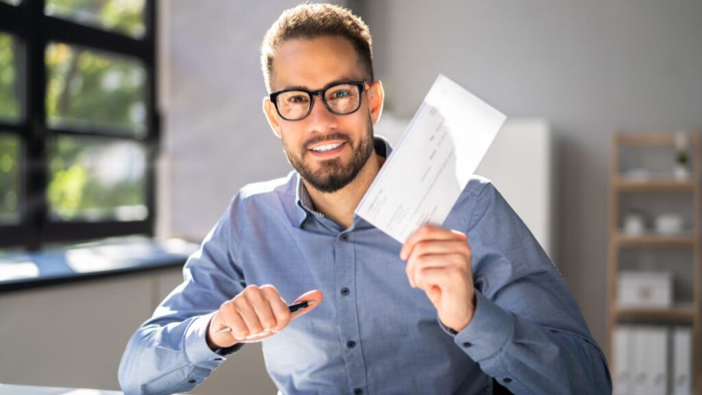 a small business owner reviewing financial documents to decide how to pay yourself