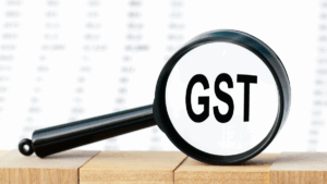 Close-up of the word GST in a magnifying glass