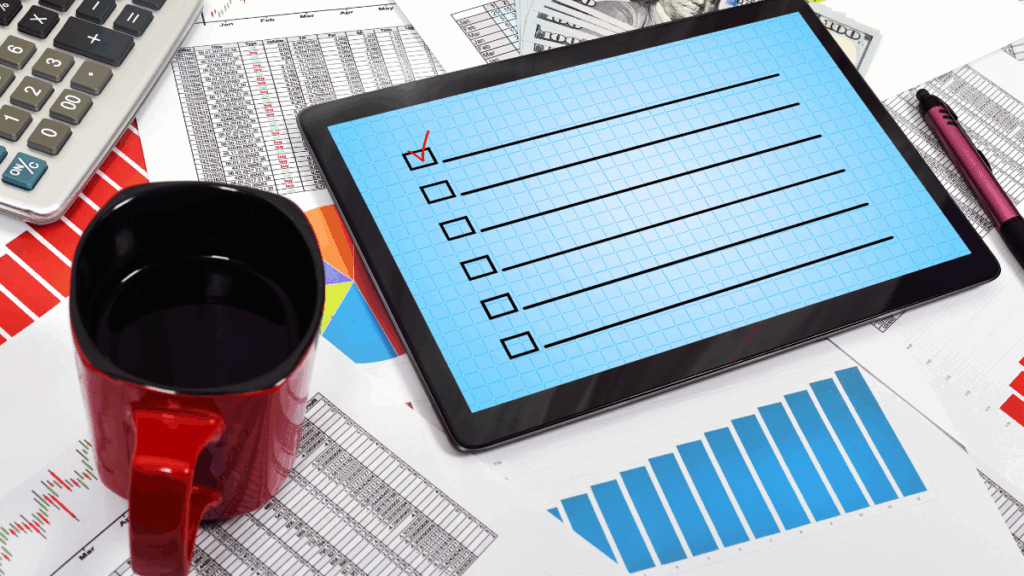 Open tablet with budget spreadsheet and coffee beside it, symbolizing stress-free financial prep