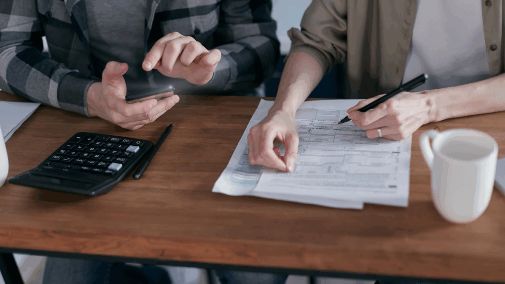 Business owner organizing receipts and financial documents for year-end tax prep