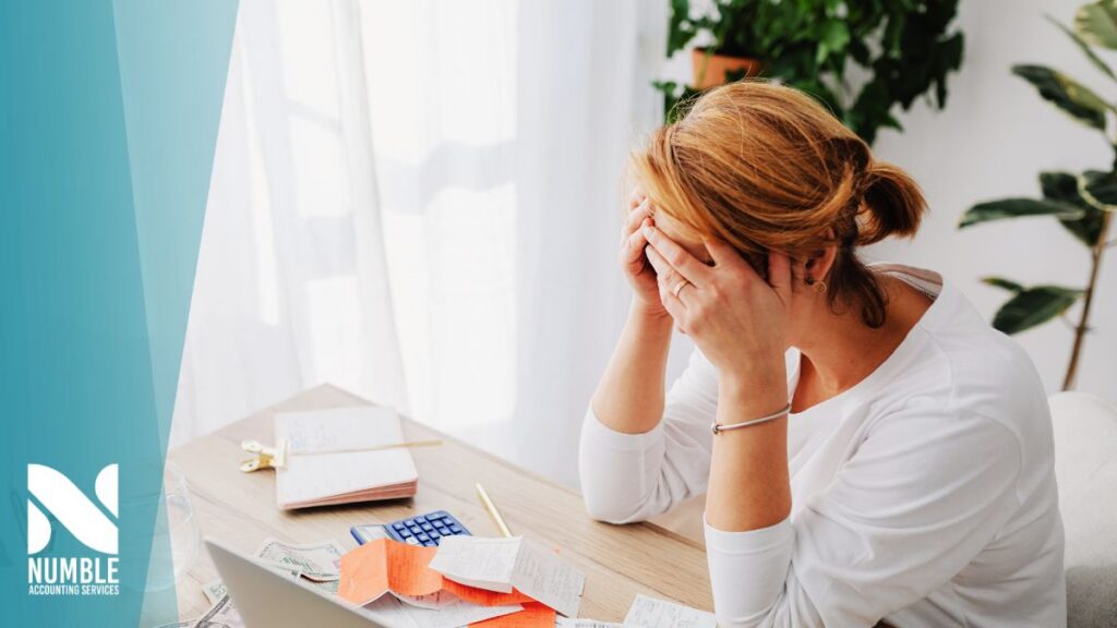 a small business owner feeling stressed over owing taxes before they called Numble Accounting