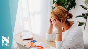 a small business owner feeling stressed over owing taxes before they called Numble Accounting