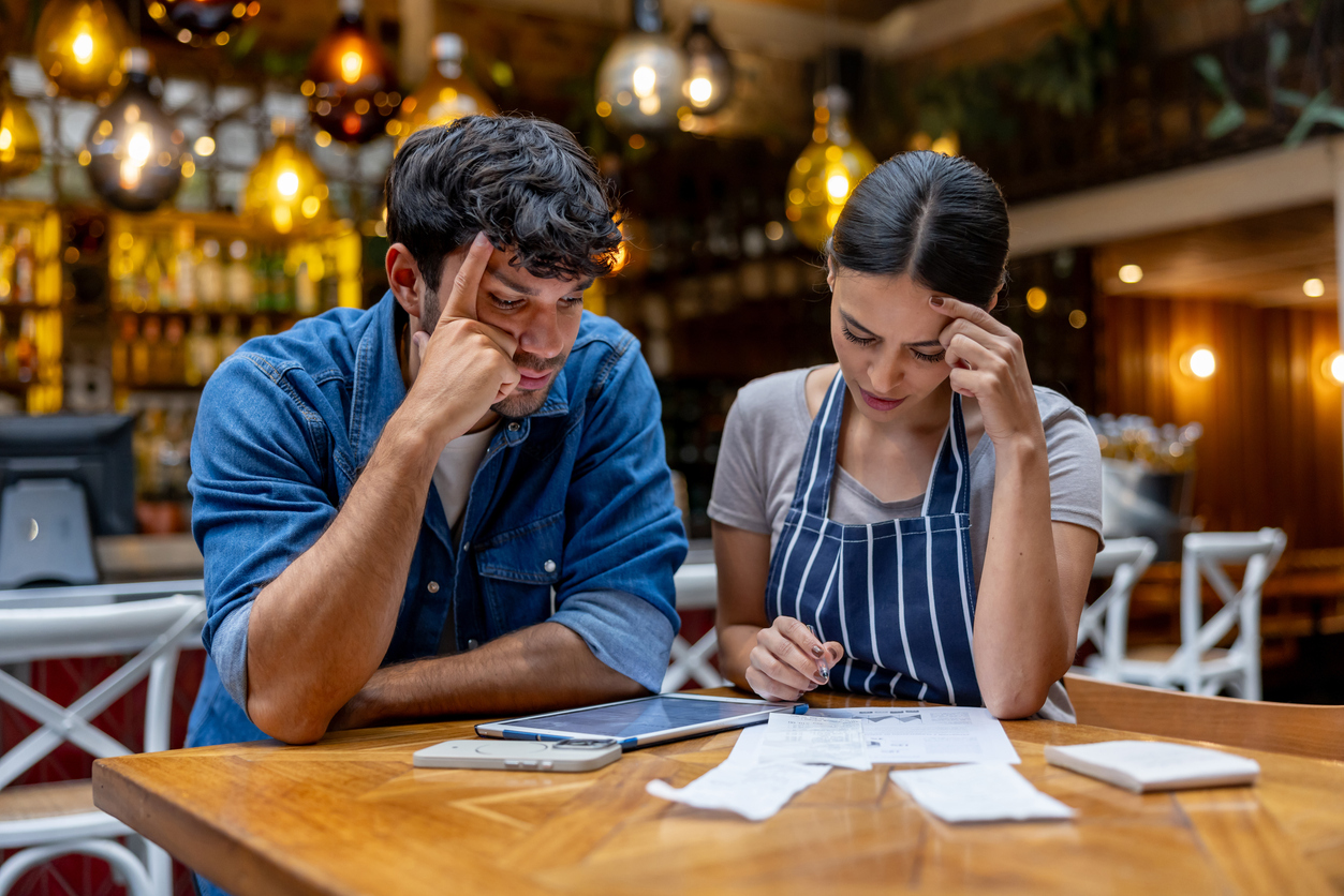 A St. Albert small-business owner reviewing monthly bookkeeping with a Numble accountant